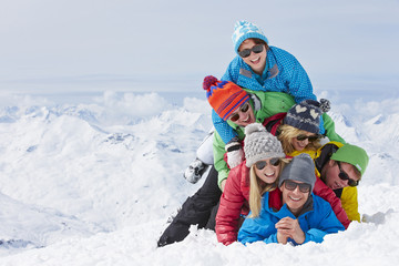 Fototapeta na wymiar Group Of Friends Having Fun On Ski Holiday In Mountains