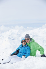 Fototapeta na wymiar Couple Having Fun On Ski Holiday In Mountains