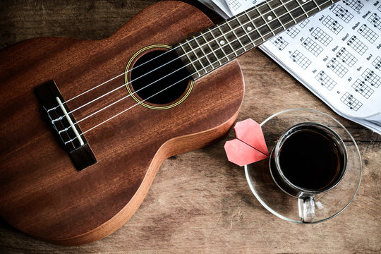 Close up of ukulele on old wooden background