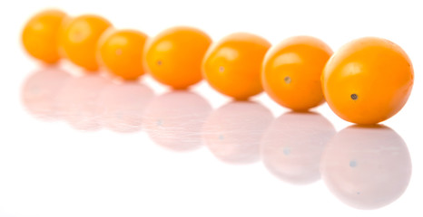 Yellow orange grape tomato over white background