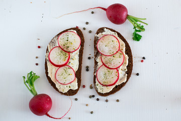 Rye bread sandwich with cream cheese and radish.