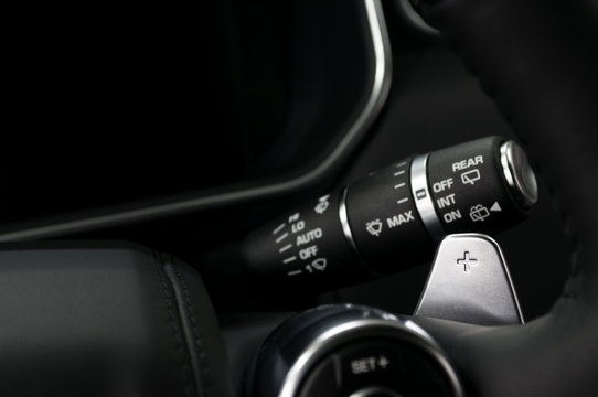 Car gear lever. Manual gear changing paddle on car's steering wheel. Interior detail.
