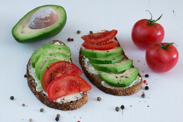 Rye bread sandwich with cream cheese,avocado and tomatoes.