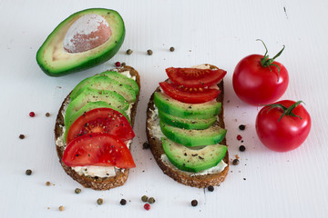 Rye bread sandwich with cream cheese,avocado and tomatoes.