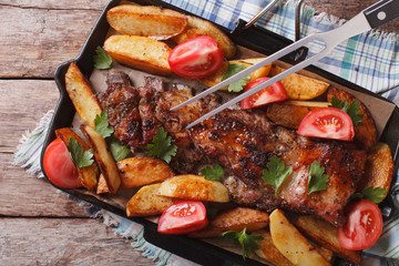 homemade barbecue: meat and potatoes horizontal top view
