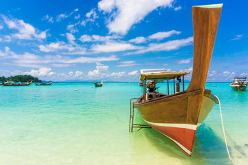Wood boat and islands in andaman sea against blue sky at Lipe