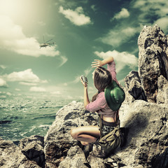 woman traveler on rock with radio transmitter