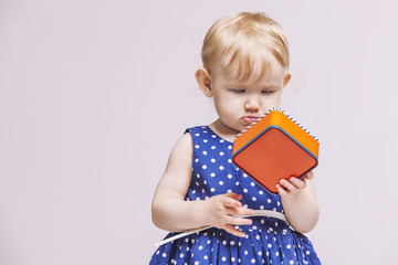 Baby girl with a box in his hands