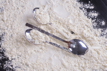 Three wooden spoons from flour on