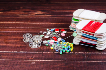 vintage bobbin and pin with spools of thread