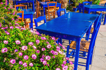 Blue tables in colorful Greek restaurant, Greece