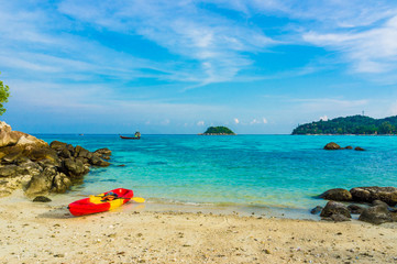 Fototapeta na wymiar Red yellow kayaks on the tropical beach, Lipe island