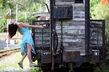 Beautiful young woman and vintage train