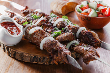 skewers shashlik kebab  with red sauce - 84469516