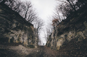 man on path between cliffs