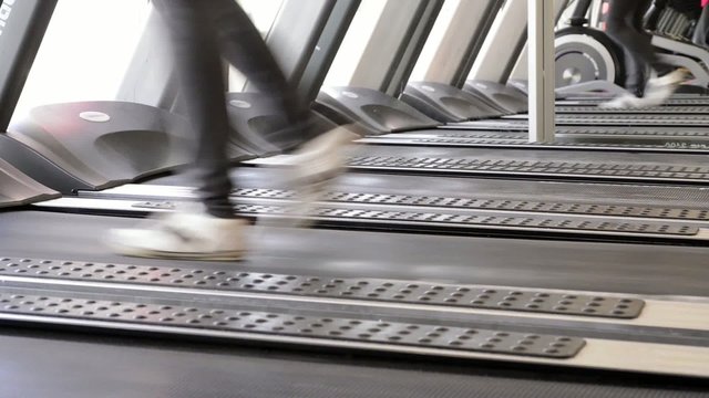 Fitness girl running on treadmill.