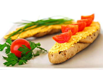 Sandwich with paprikash curd cheese and delicious vegetables on plate