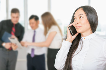 Successful asian business woman using mobile phone