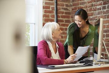 Two Businesswomen Meeting In Creative Office