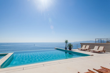 Obraz na płótnie Canvas Luxury swimming pool and blue water