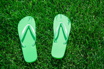 Closeup of  flip flops on green grass