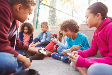 Group Of Young Children Hanging Out In Playground