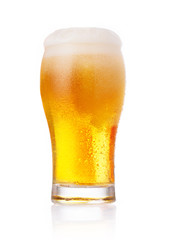 Glass of fresh beer with cap of foam isolated on white backgroun