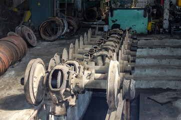 Fototapeta na wymiar The wheels of a tram on rails in the repair depot