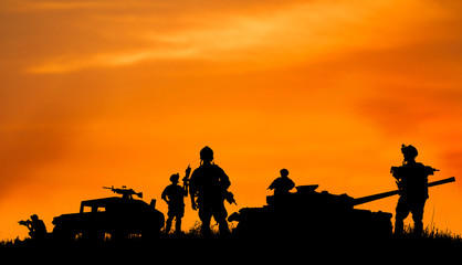 Silhouette of military soldier or officer with weapons at sunset