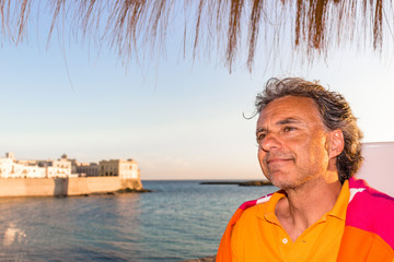 Fototapeta premium Handsome tanned relaxed man on holiday in Italy
