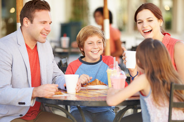 Family Enjoying Snack In CafÅ½