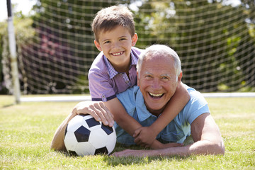 Portrait Of Grandfather And Grandson With Football