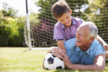 Portrait Of Grandfather And Grandson With Football