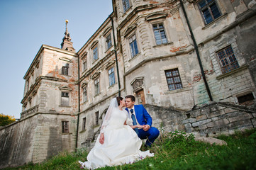 Young wedding couple on background old castle