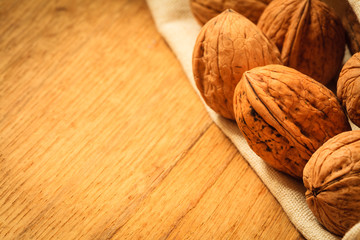 Whole walnuts on rustic old wooden table