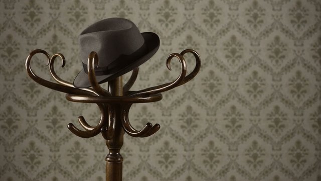 Throwing the hat on the coat rack, vintage wallpaper on background