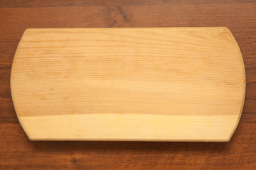 Empty cutting board on a wooden background