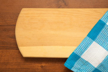 blue checkered towel in the corner of a wooden background