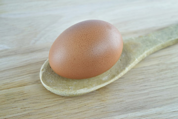 Egg in wooden spoon