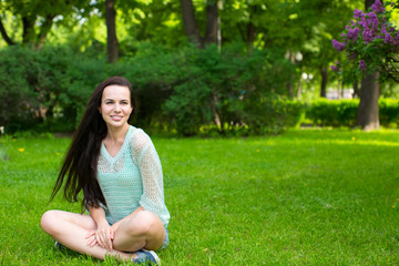 Fototapeta premium young girl in a park on the grass