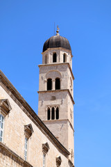Fototapeta na wymiar Franciscan monastery bell tower in Stradun, main street in Dubrovnik. 