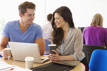 Two Mature Students Working Together Using Laptop
