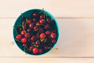 Fresh organic Cherries on a white wooden table