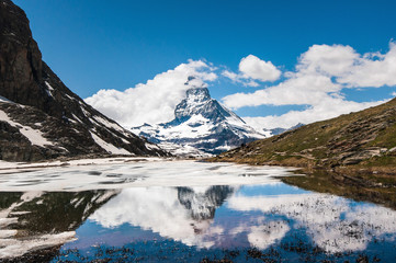Naklejka na ściany i meble Reflection of Matterhorn in the swiss alps