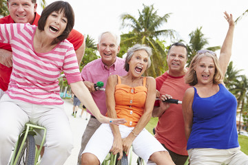 Group Of Senior Friends Having Fun On Bicycle Ride