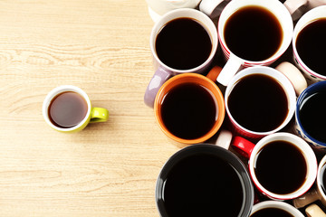 Fototapeta na wymiar Many cups of coffee on wooden table background, closeup view