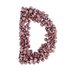 Alphabet from chocolate chips on white background
