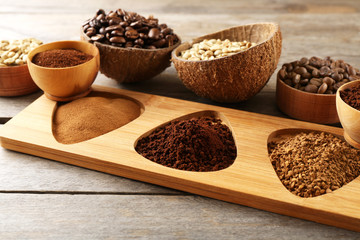 Various of coffee in small dishes on wooden table, closeup