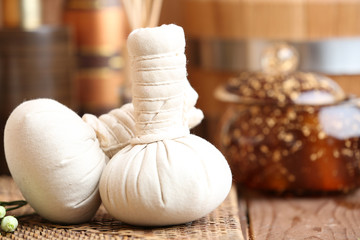 Beautiful spa composition with massage bags on table close up