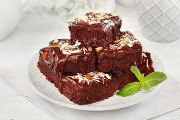 Delicious chocolate cakes on plate on table close-up